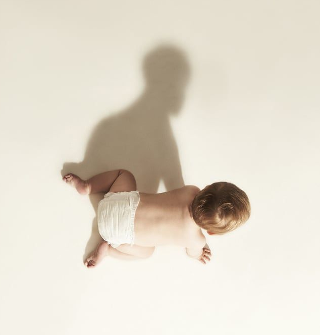 Baby lying on a soft neutral background